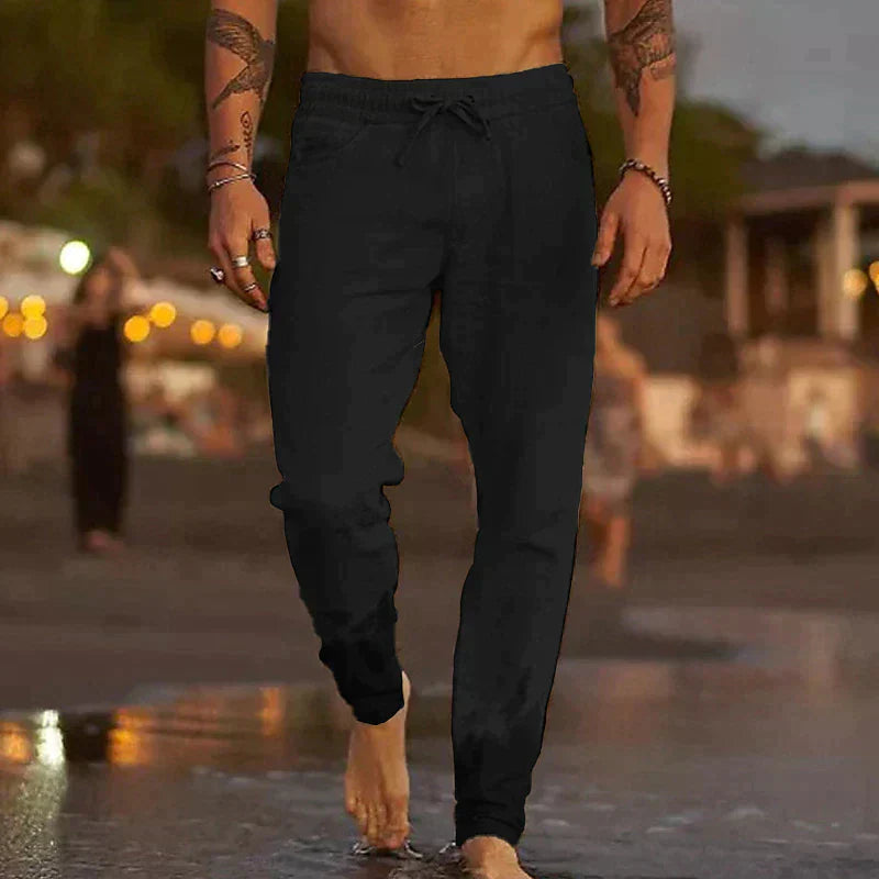 Close-up of men's lightweight linen trousers fabric, showing breathable texture & casual fit.