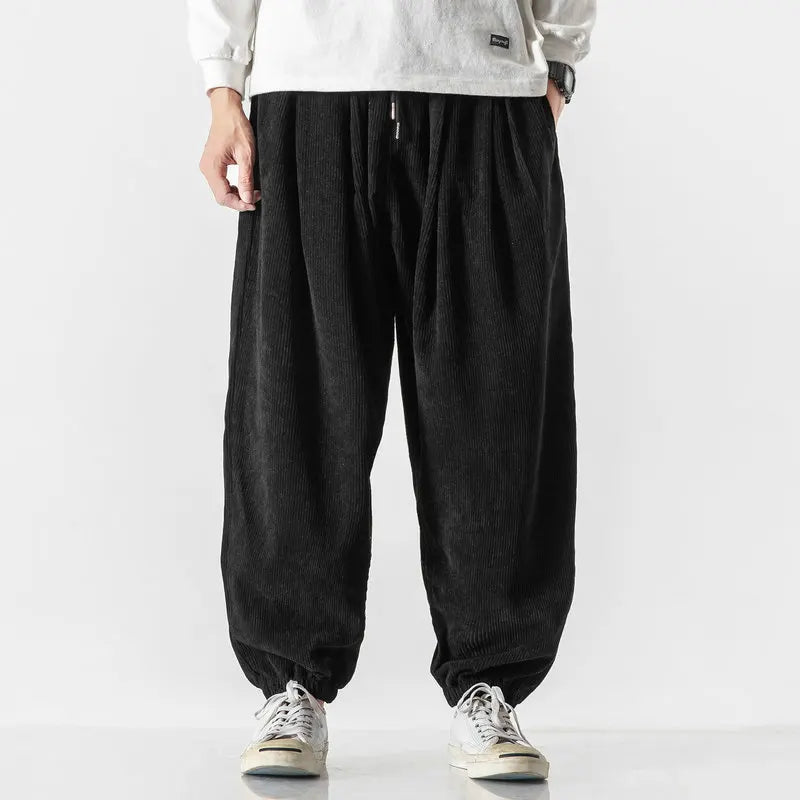 Comfortable men's wide leg corduroy pants for casual street style, versatile for fall & winter fashion.