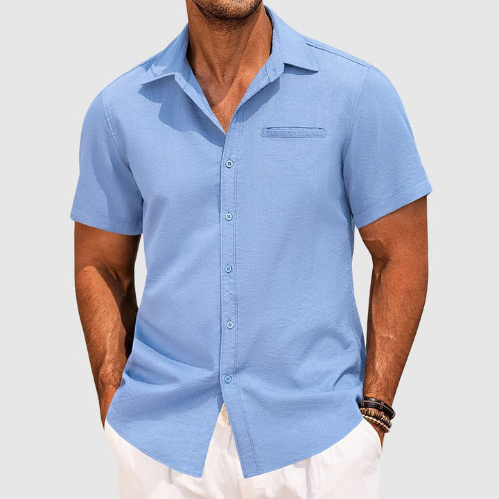 Close-up of the men's short sleeve button-down summer shirt, highlighting the chest pocket and button placket.