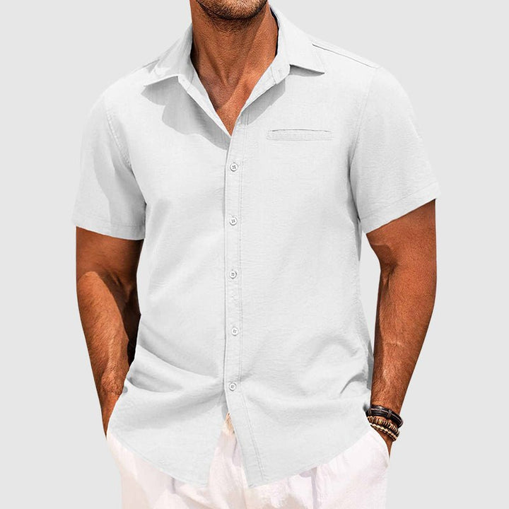 Men's modern short sleeve button-down summer shirt styled for a relaxed, casual warm weather look. Features chest pocket.