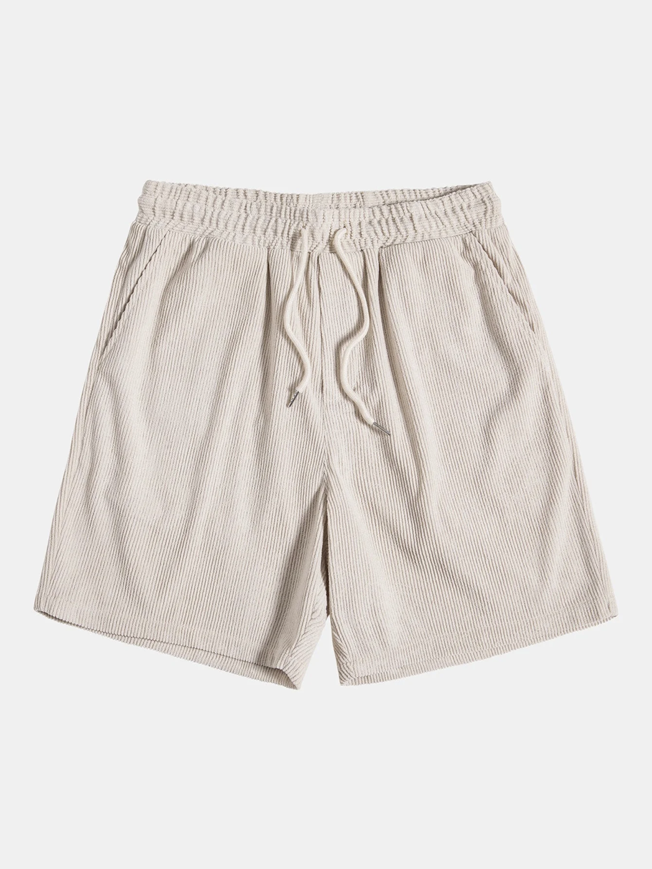 Close-up of the fabric texture on a men's corduroy shorts and matching summer shirt set