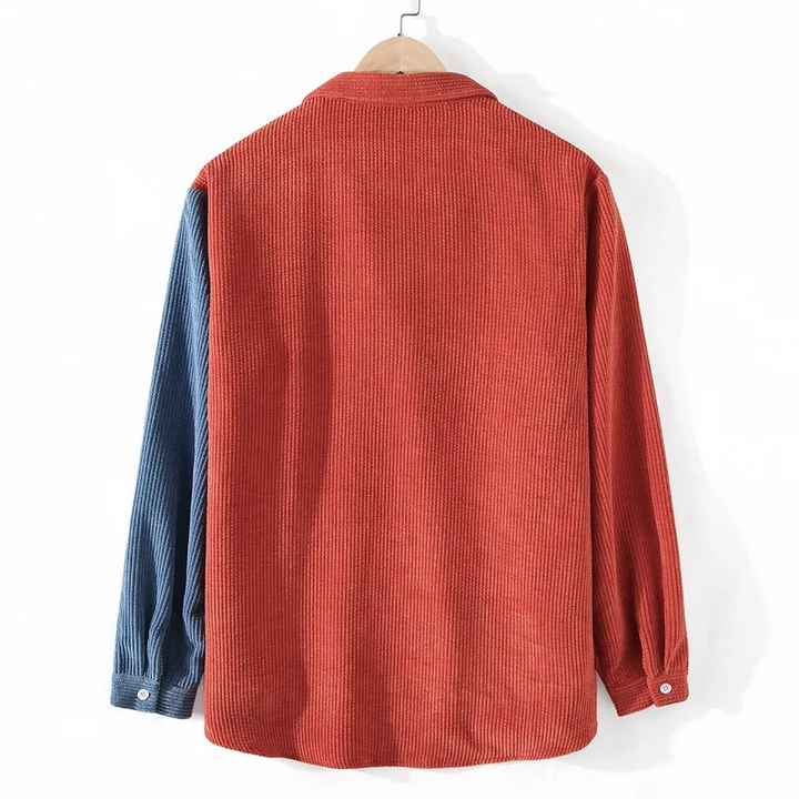 Close-up of men's color block button-up shirt, showcasing splice details, fabric texture & buttons. Modern apparel.
