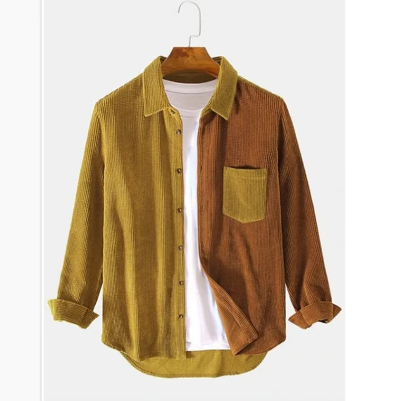 Men's splice color block button-up shirt on a hanger. Detailed view of stitching, colors & casual modern design.