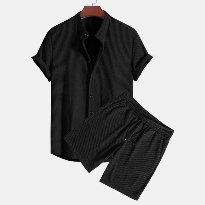 Stylish men's two-piece polo set, mandarin collar top & matching shorts for casual summer wear.