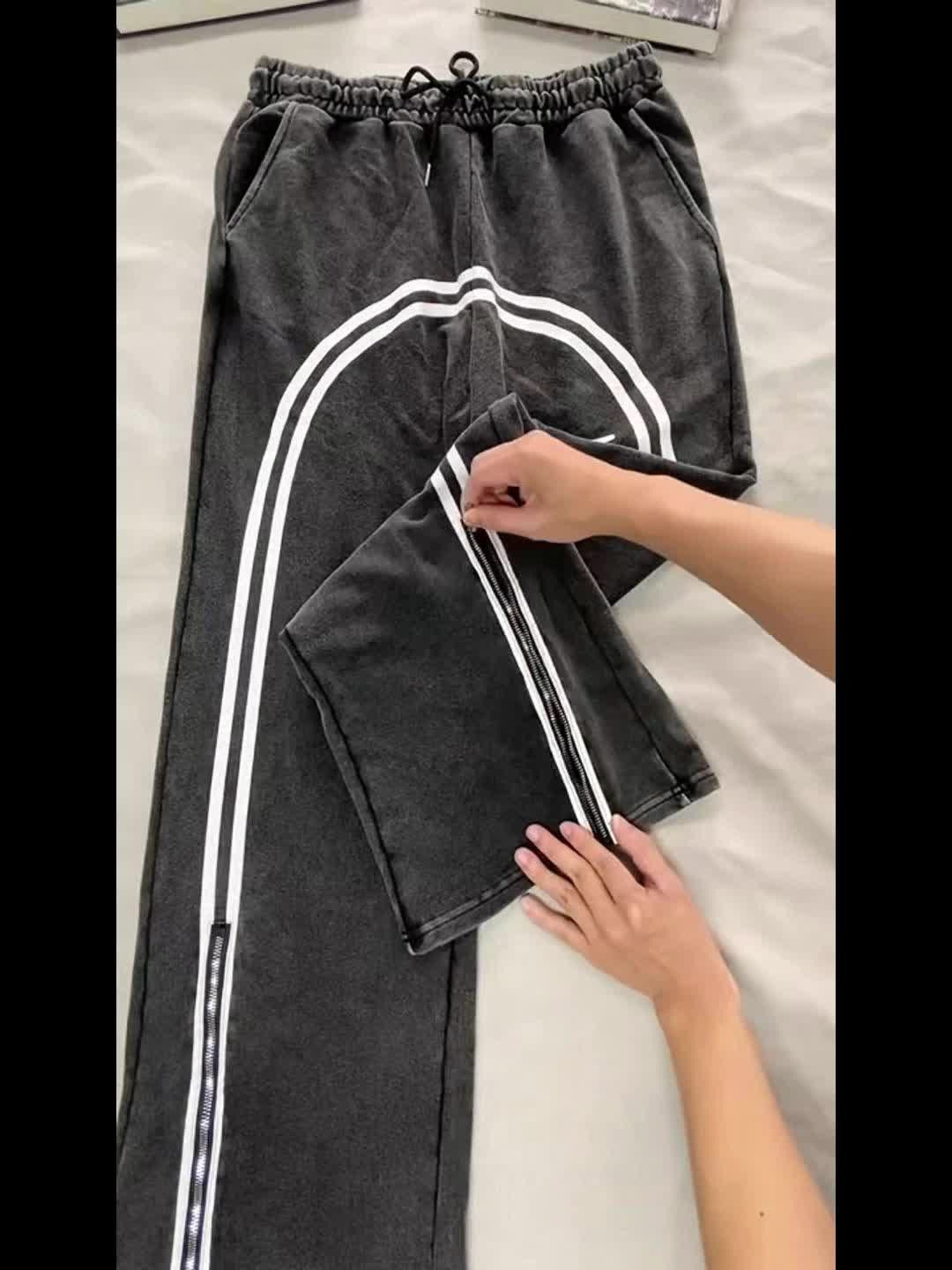 Men's Catania track pants with zipped hems, ideal for athletic wear & casual style.