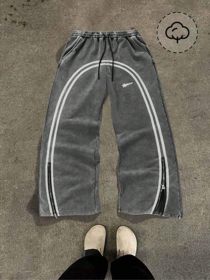 Stylish men's Catania track pants, tapered, featuring practical zipped hems & side stripe.
