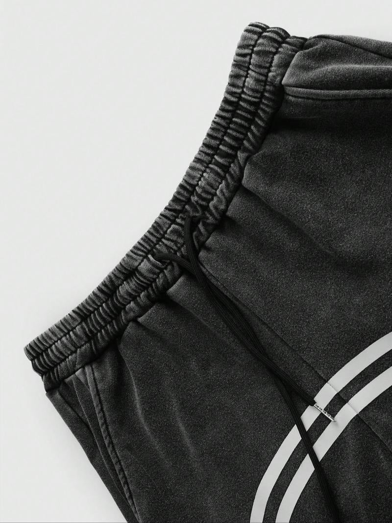 Black men's Catania track pants, tapered fit, with functional zip hems for street fashion.