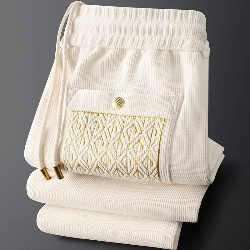 Men's Cavo comfort trousers with luxurious gold detail, perfect for modern casual wear.