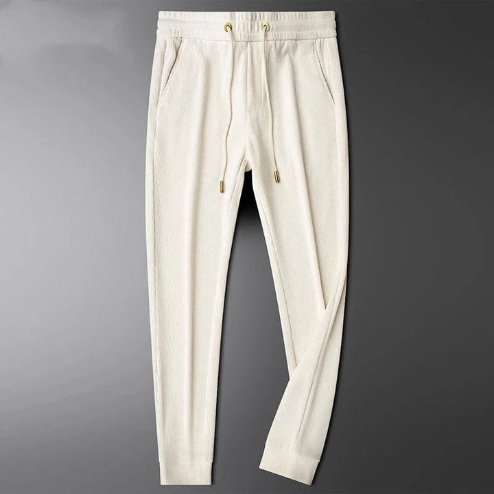 Comfort-focused men's Cavo trousers, versatile bottoms featuring elegant gold accents.