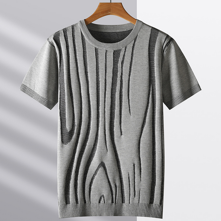 Close-up of men's textured knit tee, showcasing the intricate sculpted woodgrain pattern. Unique style.