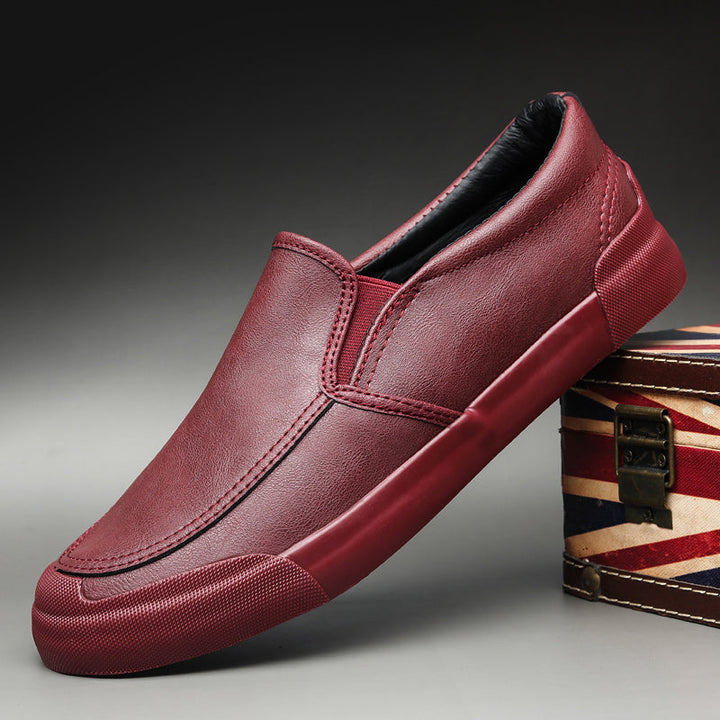 Stylish gray men's Chelsea style slip-on sneakers. Comfortable casual footwear for modern men's fashion.