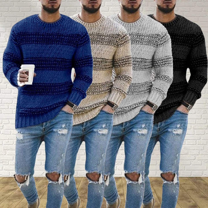 A man wearing a grey chunky knit Scandinavian sweater, offering warmth and casual style for winter.
