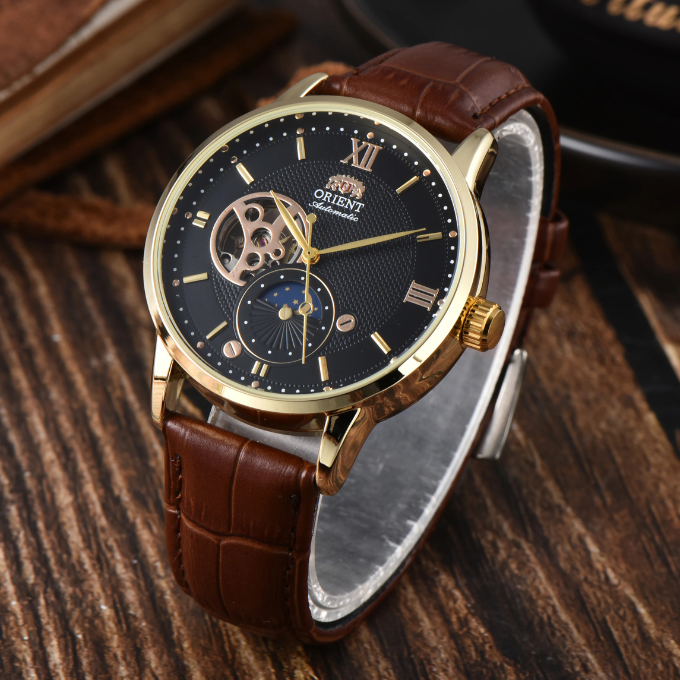 Close-up of men's automatic sun & moon watch dial, showing intricate day/night indicator, elegant vintage style.