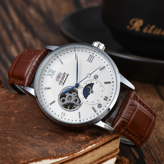 Men's classic automatic sun & moon watch on a wrist, displaying its elegant vintage aesthetic and leather strap.