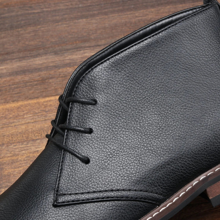 Sleek black men's chukka boots, versatile for casual outfits & dressy occasions. Features a comfortable grip sole.