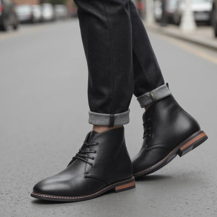 Full view of classic men's black chukka boots, durable design with a cushioned, comfortable grip sole.