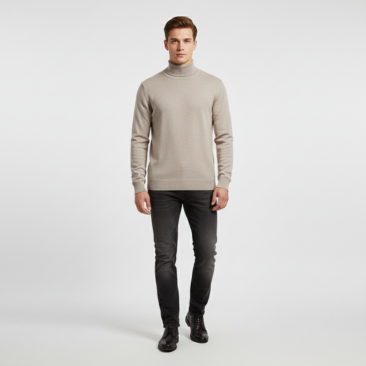 Stylish man wearing a classic cream cotton roll-neck jumper, showcasing versatile menswear