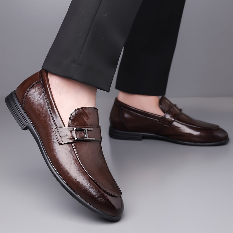 Men's black classic lace-up dress shoes styled on foot, completing a sophisticated professional outfit.