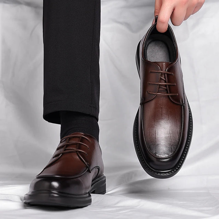 Men's brown leather lace-up dress shoes worn, showcasing elegant and sophisticated formal footwear.
