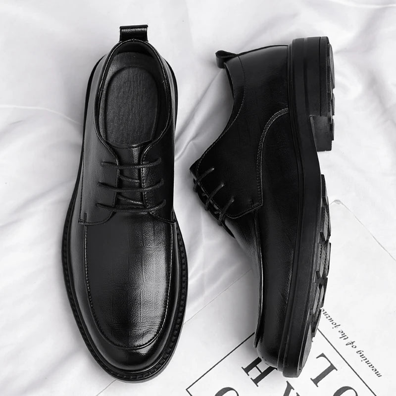 Close-up of high-quality men's classic leather lace-up dress shoes, showcasing fine craftsmanship & sophisticated design.