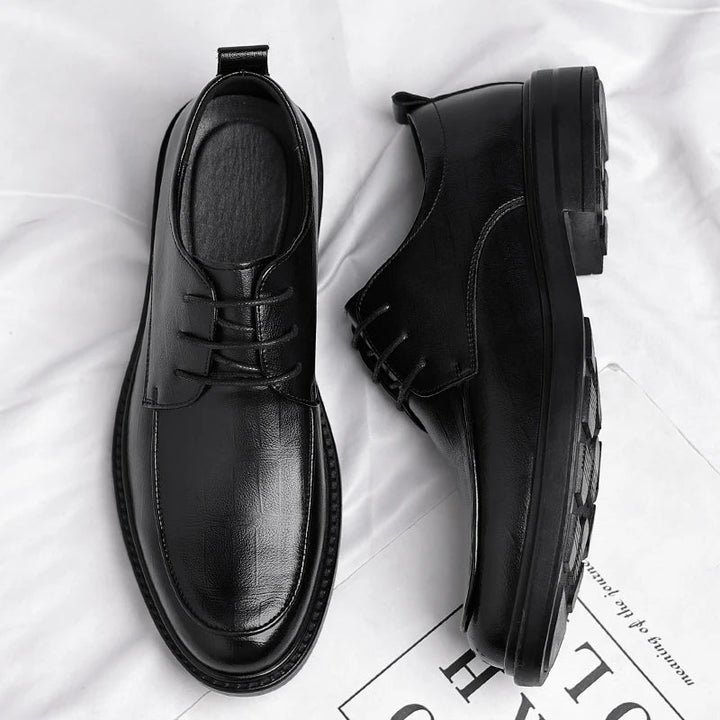 Close-up of high-quality men's classic leather lace-up dress shoes, showcasing fine craftsmanship & sophisticated design.