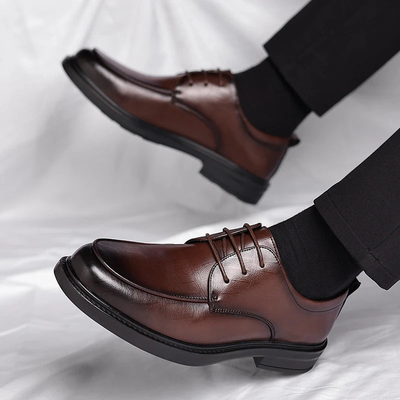 A pair of polished men's classic lace-up dress shoes, essential sophisticated footwear for modern men's fashion.