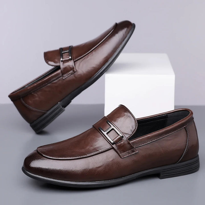 Detailed view of elegant laces on men's black leather dress shoes, emphasizing classic and sophisticated style.