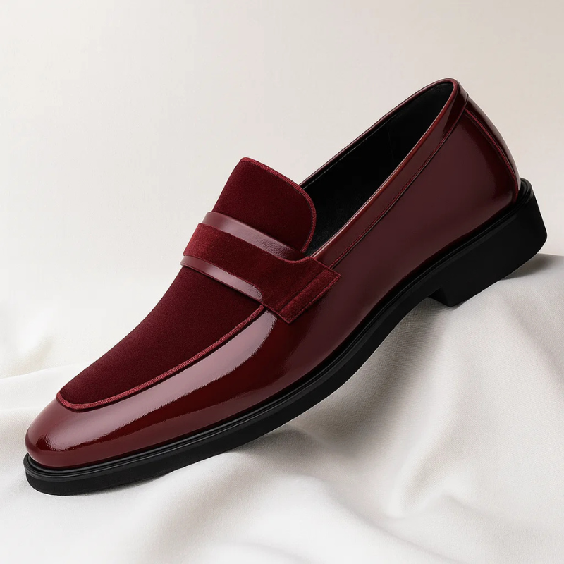 Close-up of sleek men's classic black penny loafers, comfortable & stylish leather footwear, ideal for formal outfits.