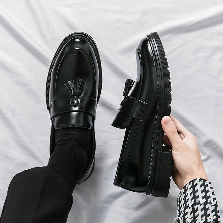 Men's classic black leather tassel loafers. Elegant slip-on dress shoes for formal & business occasions.
