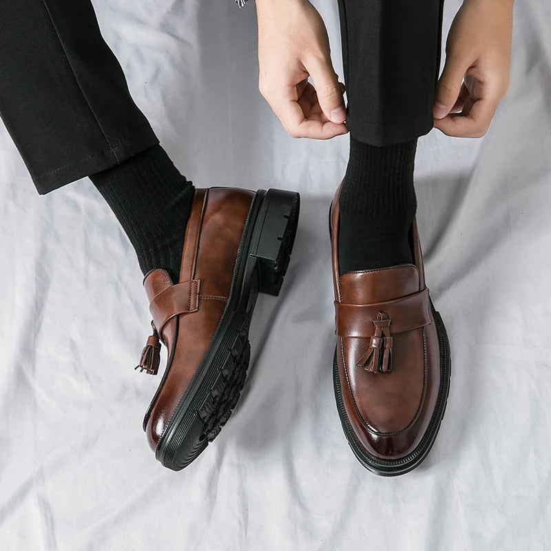 Front view of men's classic brown leather tassel loafers. Smart casual & business slip-on dress shoes.