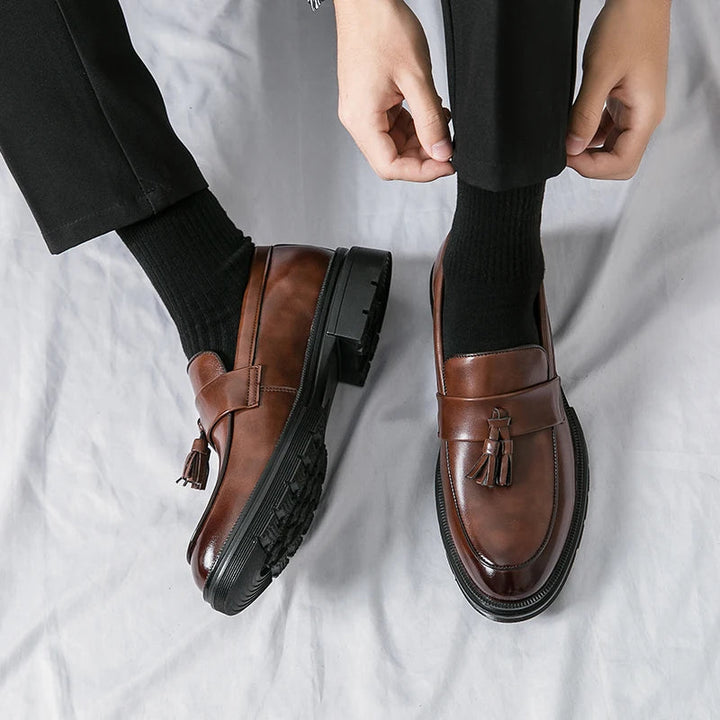 Front view of men's classic brown leather tassel loafers. Smart casual & business slip-on dress shoes.