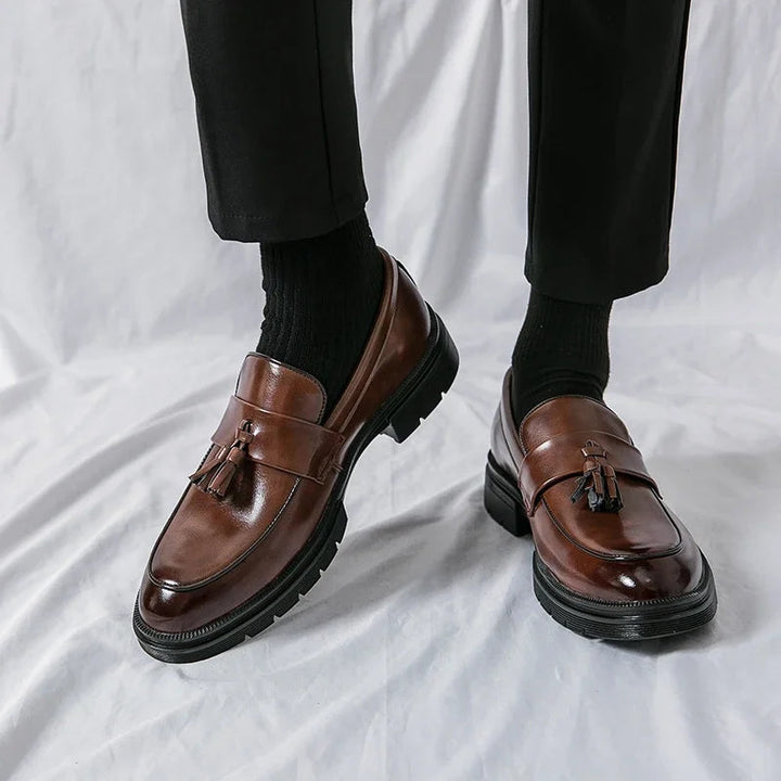 Durable sole of men's brown leather tassel loafers, classic and comfortable slip-on dress shoes.