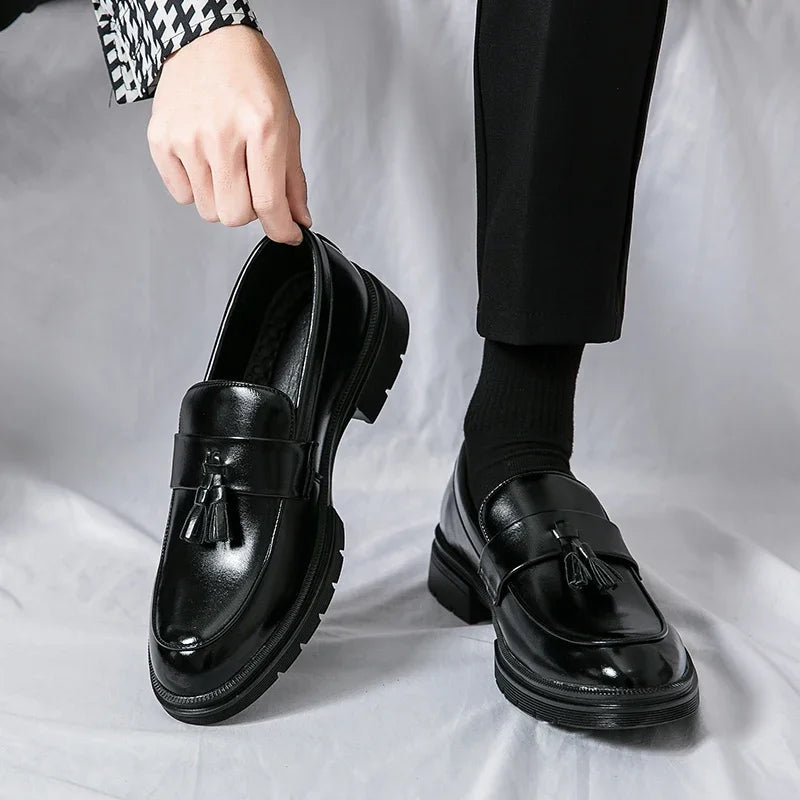 Close-up of men's elegant black leather tassel loafers. Classic smart casual footwear for comfort.