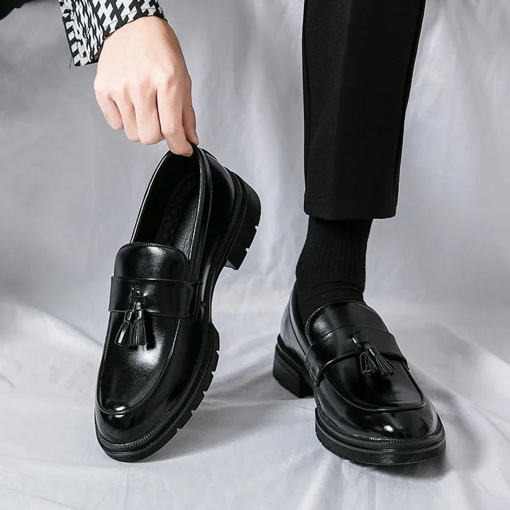 Close-up of men's elegant black leather tassel loafers. Classic smart casual footwear for comfort.
