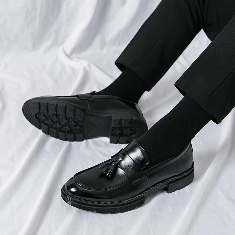 Men's smooth brown leather tassel loafers. Classic formal dress shoes for a polished business and elegant look.
