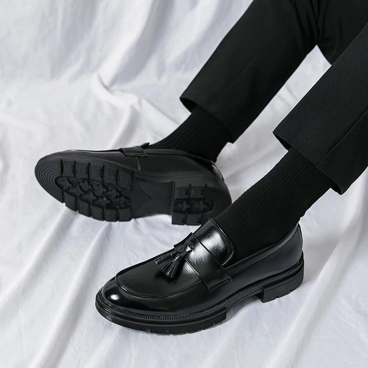 Men's smooth brown leather tassel loafers. Classic formal dress shoes for a polished business and elegant look.