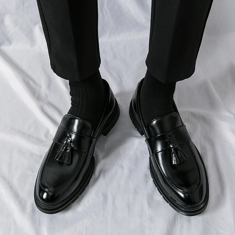 Comfortable men's black leather tassel loafers. Elegant slip-on casual & business footwear for daily wear.
