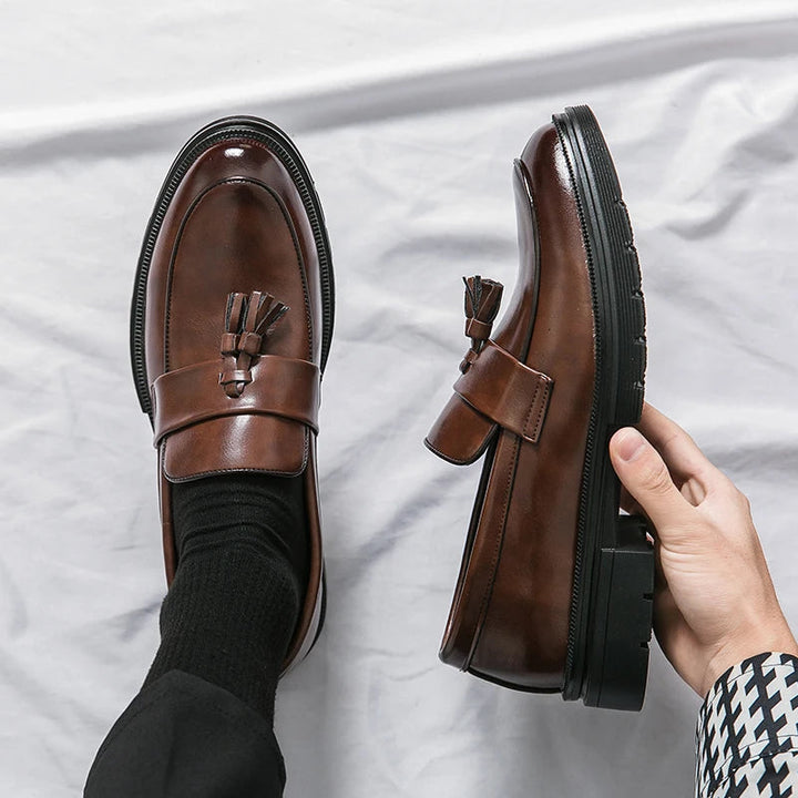 Classic men's black leather tassel loafers. Elegant slip-on footwear, perfect for dress & casual occasions.