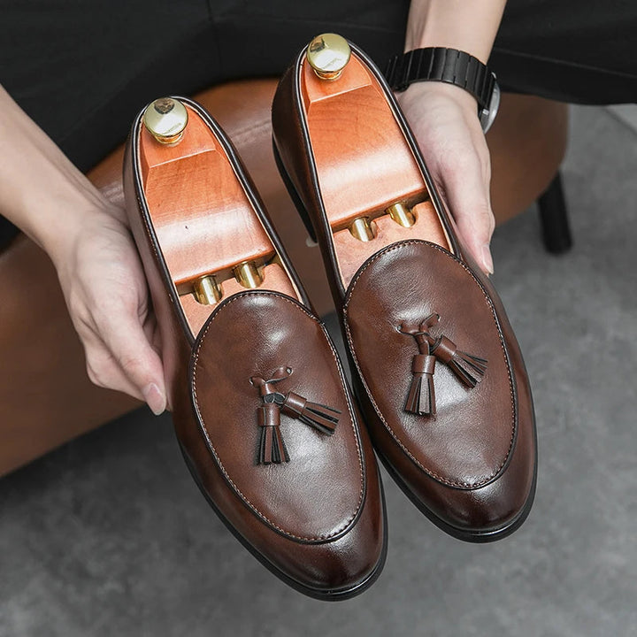 Top-down view: brown men's tassel loafers. Slip-on comfort & timeless style for any refined outfit.