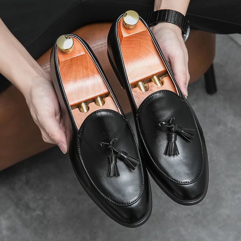 Close-up of elegant men's leather tassel loafers, highlighting refined craftsmanship and style.