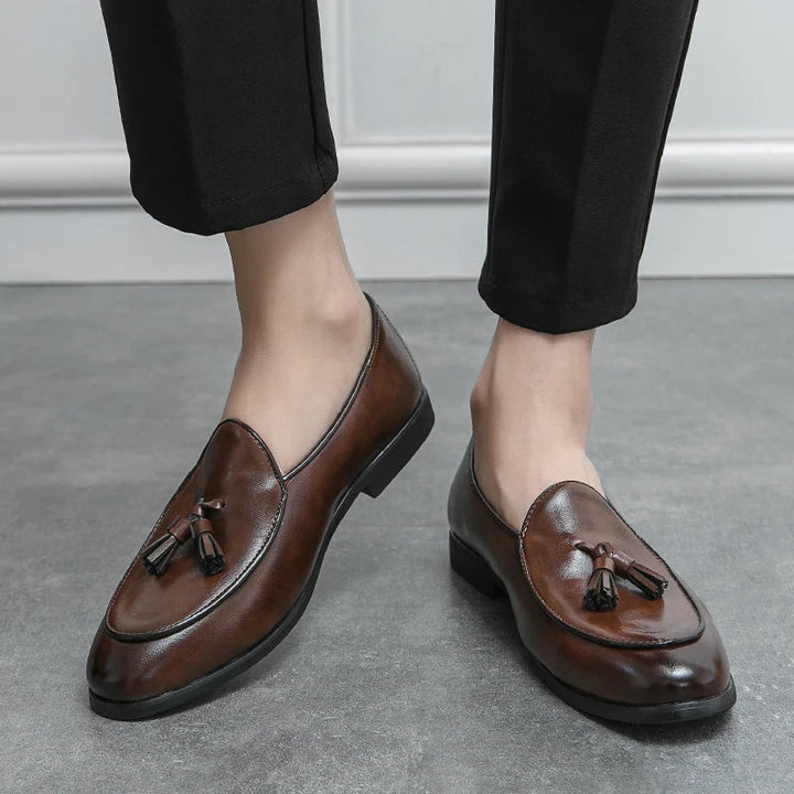 Men's sophisticated tassel loafers. Elegant slip-on dress shoes, enhancing smart or formal outfits.