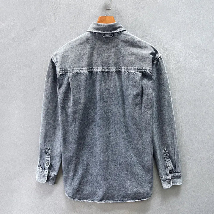 Versatile men's denim shirt in a classic wash, long sleeve button-up, offering timeless style & comfort.
