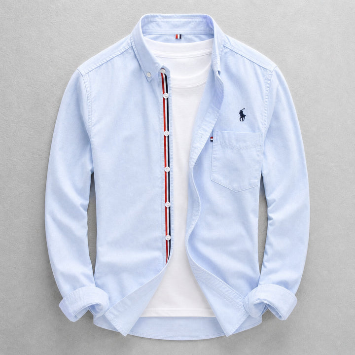 Men's classic blue Oxford shirt, tailored fit, long sleeve button-down for smart casual & everyday wear. Versatile style.