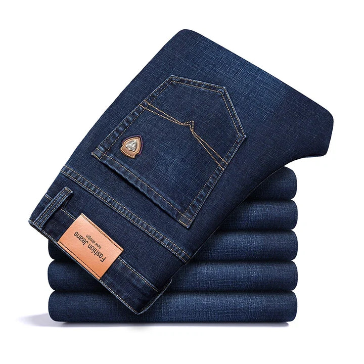 Man sitting comfortably in men's stretch denim jeans, highlighting flexibility & lasting comfort.