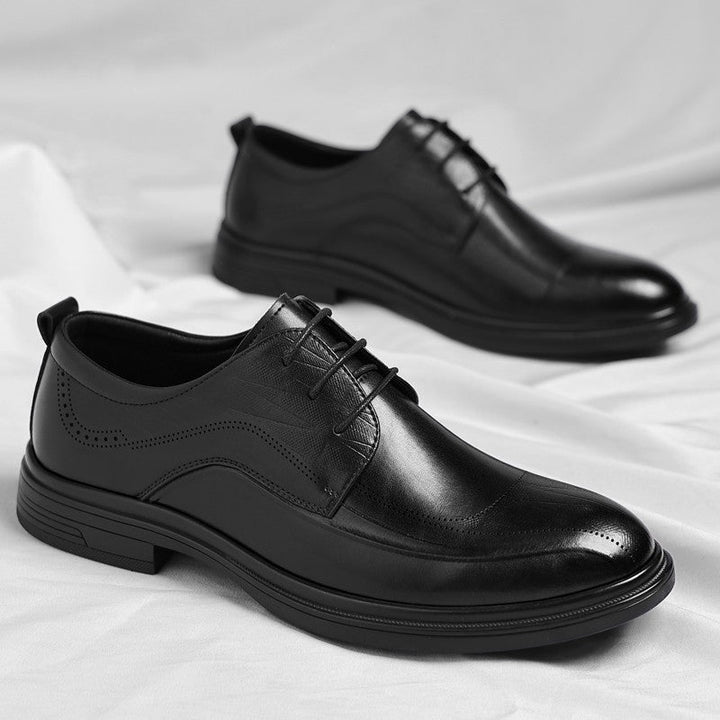 Black leather men's classic brogue dress shoes, essential formal business footwear for the modern man.