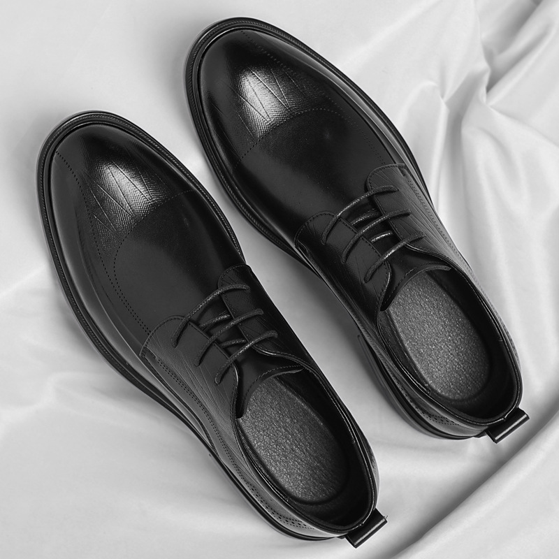 Men's classic brogue dress shoes with intricate perforations, elegant leather footwear for business formal.