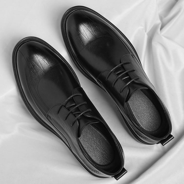 Men's classic brogue dress shoes with intricate perforations, elegant leather footwear for business formal.