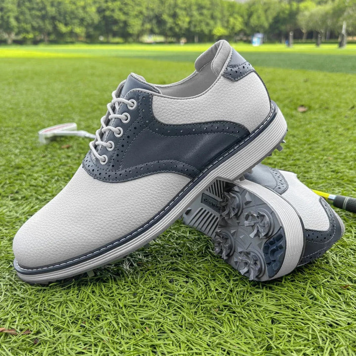 Men's classic brogue golf shoes on a golf green, spiked, water-resistant, ready for play.