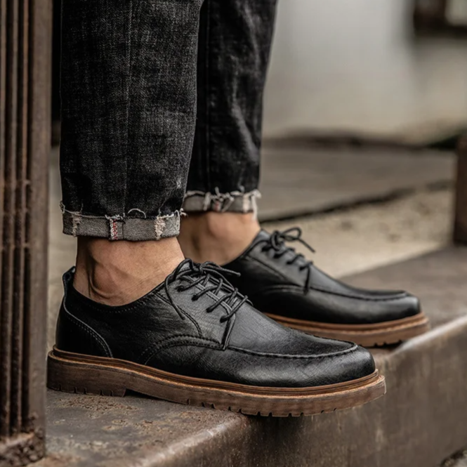 Rich brown polished men's classic lace-up Derby shoes, premium leather for formal or business casual footwear.
