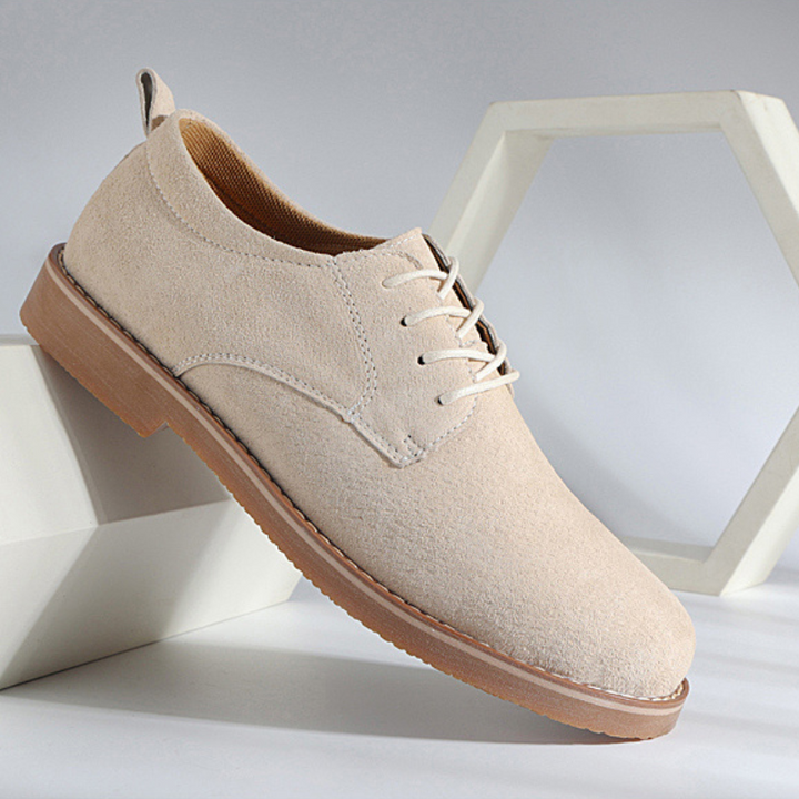 Close-up of premium brown leather men's Oxford shoes, showcasing durable texture, perfect for smart casual & winter wear.